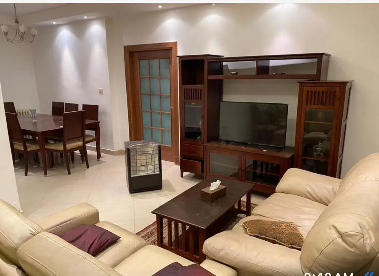 Furnished ground-floor 2-bedroom apartment with private garden for rent in Al Gardens