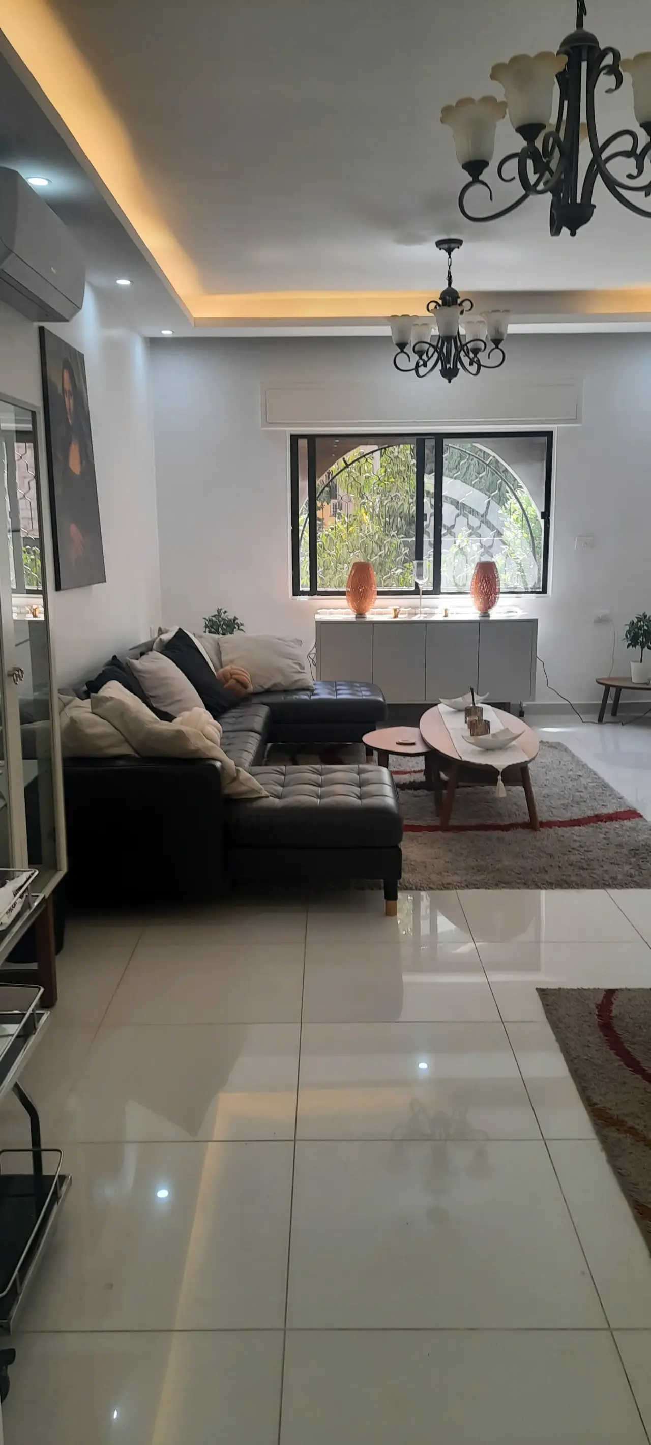 Renovated furnished ground-floor apartment with private garden and garage in Umm Uthaina