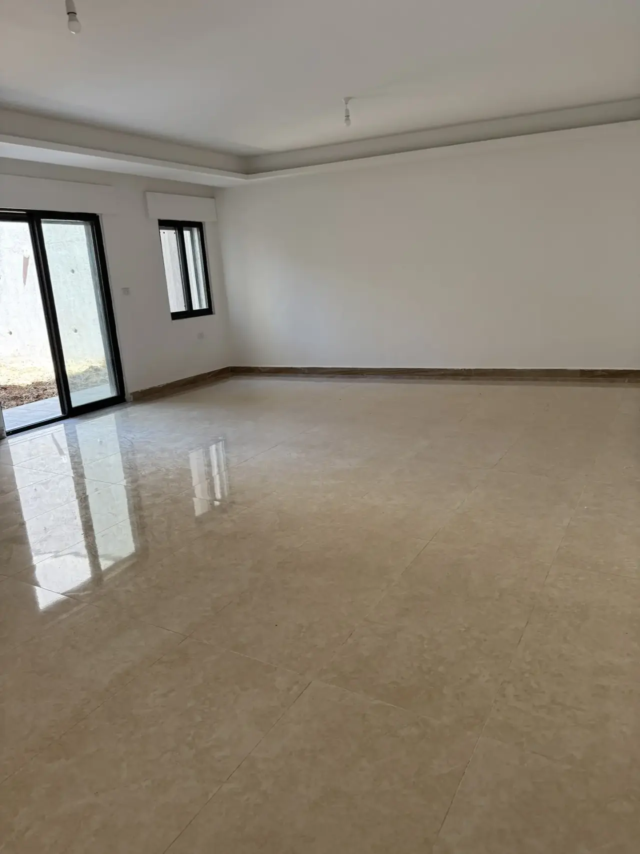 New semi-ground 3-bedroom apartment with central AC and two gardens for rent off Airport Road