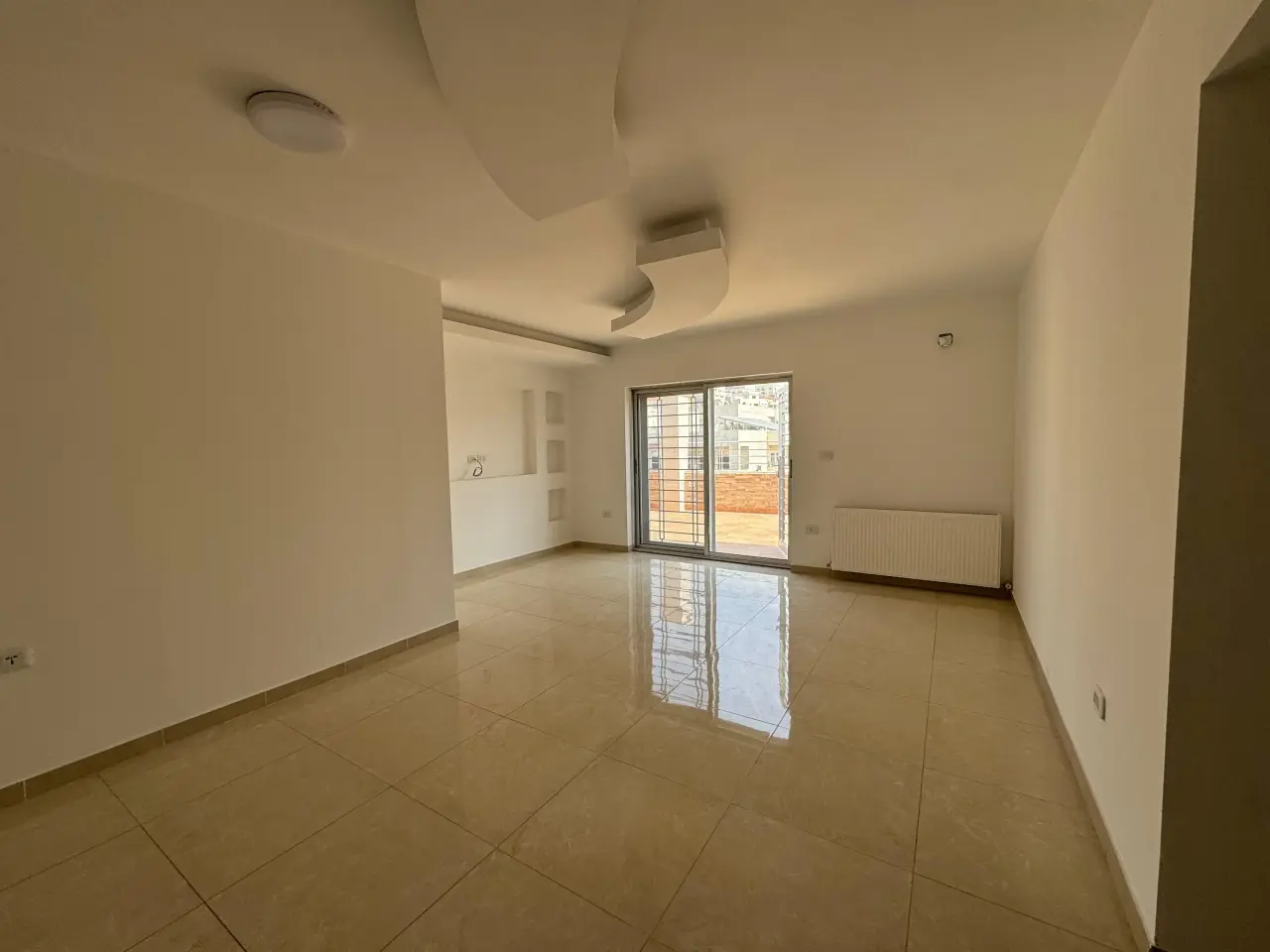 Off Airport Road in Dahyet Al Nakheel: 120 m² roof flat with 80 m² of terraces, yearly rent