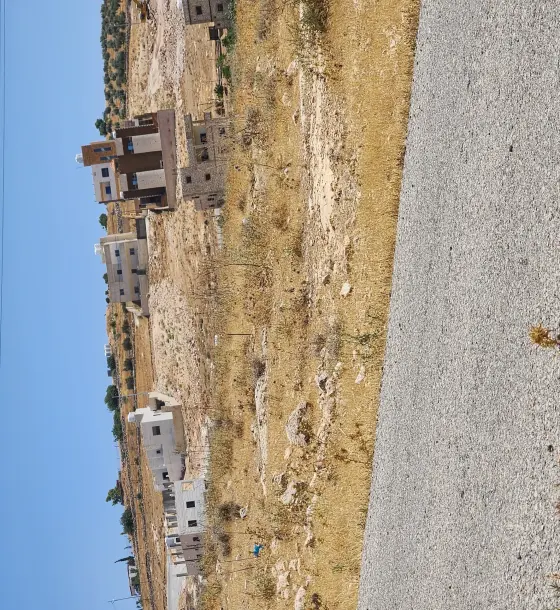 695 m² zone B plot in Rajm Al Shawk, 700 m from Shafa Badran, corner of two 12 m streets