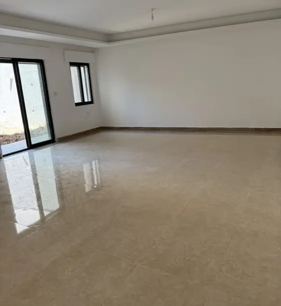 New semi-ground 3-bedroom apartment with central AC and two gardens for rent off Airport Road